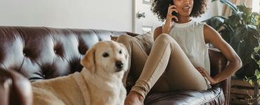 Therapist relaxing at home with a dog, symbolising balance, rest and how reclaimed time can be spent meaningfully outside work.